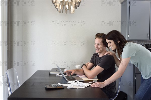 Caucasian couple using laptop