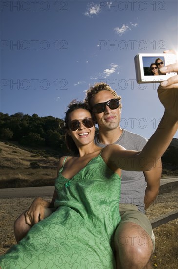 Couple taking self-portrait with camera