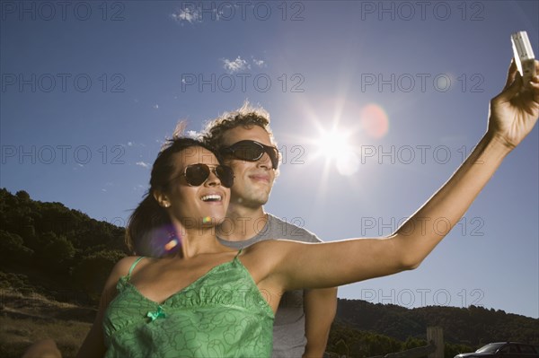 Couple taking self-portrait with camera