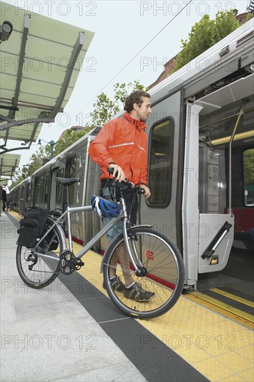 Man boarding subway with bike