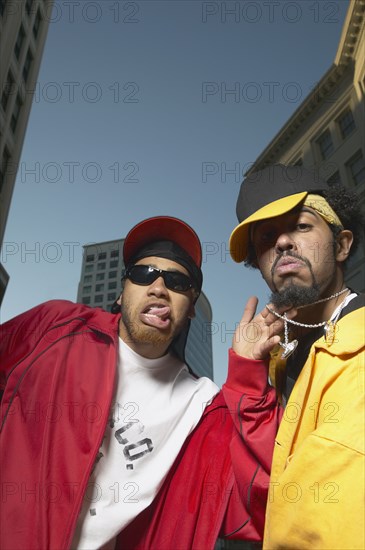 Two young African men acting goofy in urban area