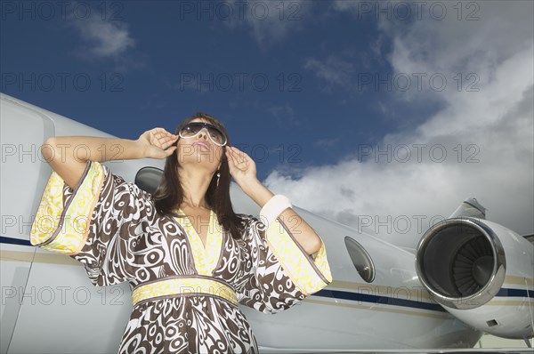 Woman standing in front of small jet