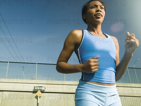 Female athlete running in urban surroundings