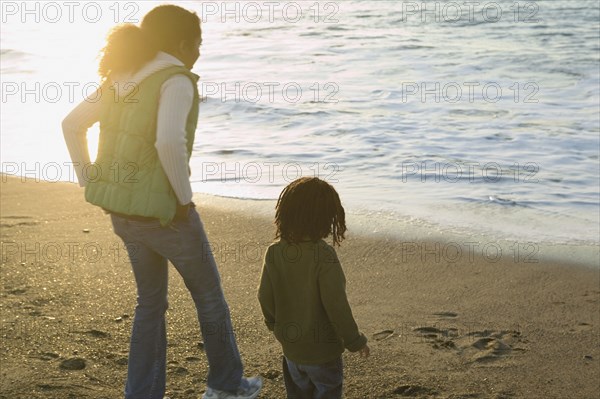 Mother and son walking on the beach