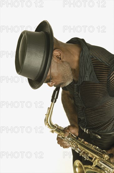 Middle aged man playing the saxophone