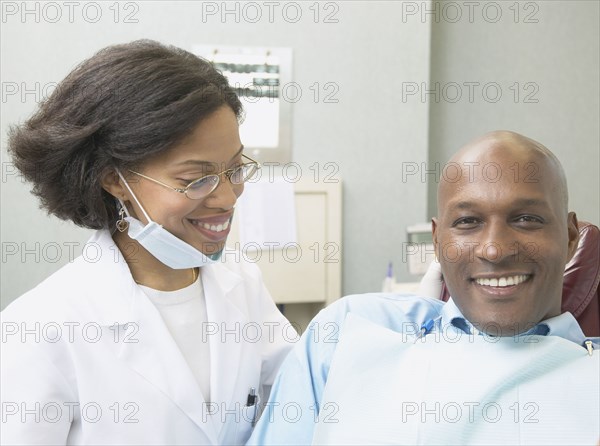 African female dentist with male patient