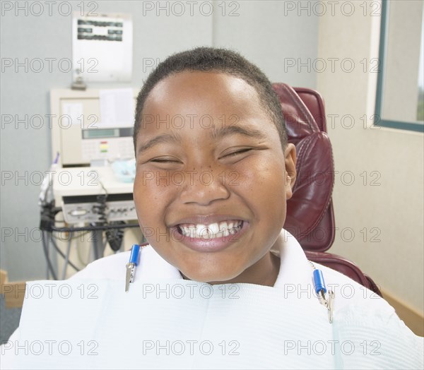 African boy smiling in dentist's chair