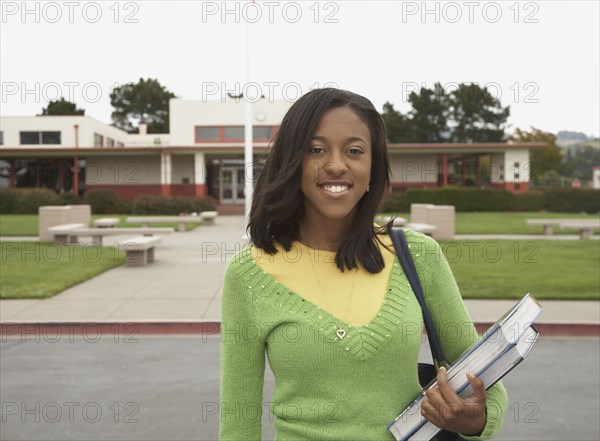 Young African woman smiling on school campus