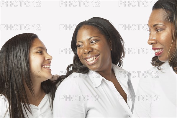 Studio shot of African mother and daughters smiling