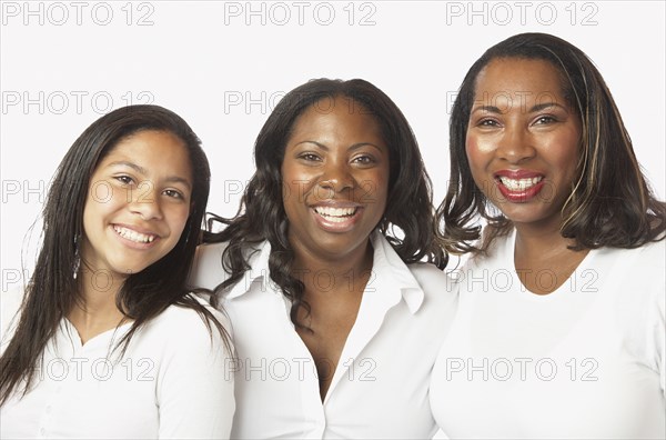 Studio shot of African mother and daughters smiling