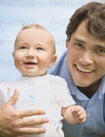 Hispanic father holding baby