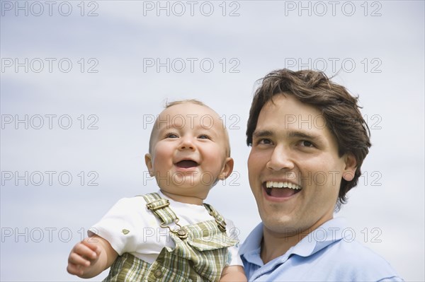 Hispanic father holding baby