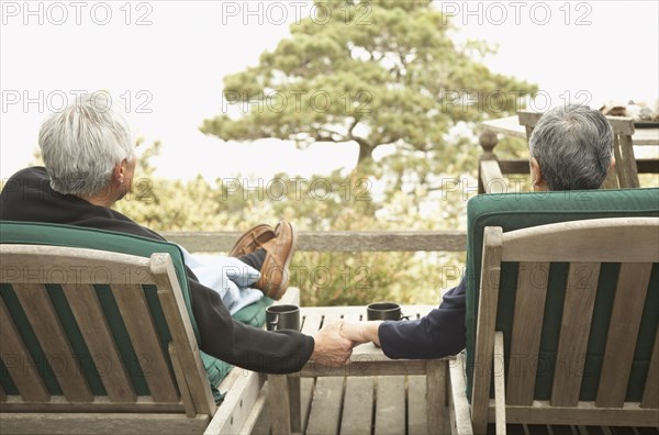 Senior couple holding hands outdoors