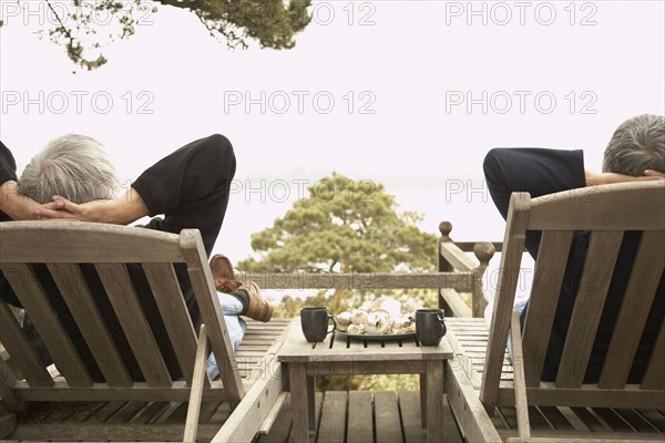 Senior couple relaxing in deck chairs