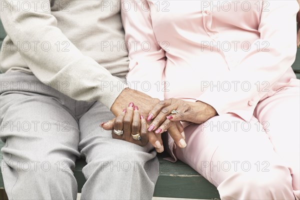 Close up of African couple holding hands