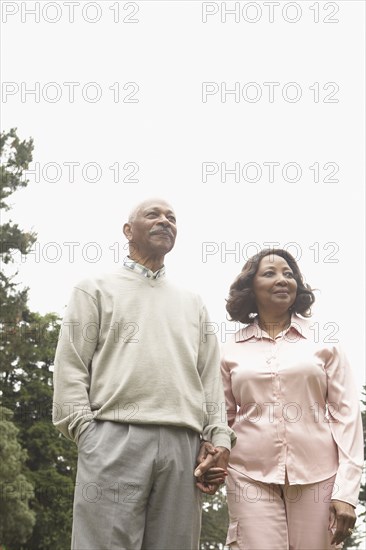 Senior African couple holding hands outdoors