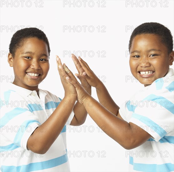 Young African twin brothers smiling