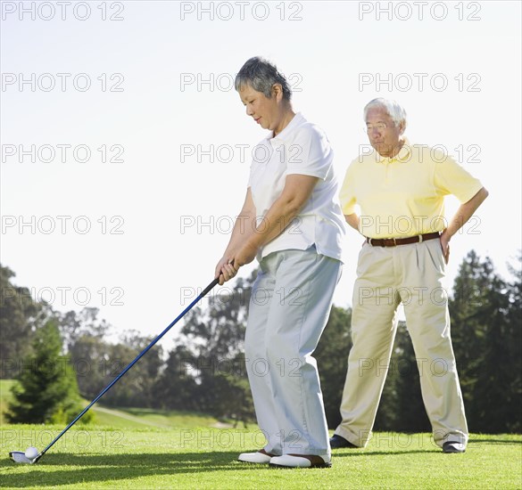 Senior Asian woman playing golf