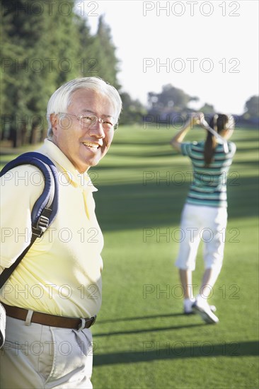 Senior Asian man on golf course