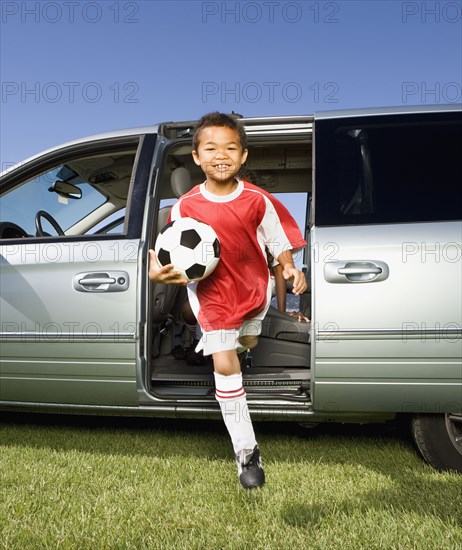 Mixed Race boy holding soccer ball