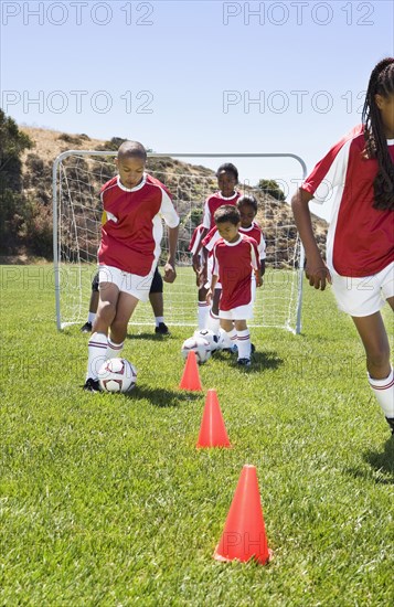 Multi-ethnic children playing soccer