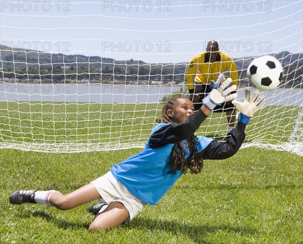 Mixed Race girl playing soccer