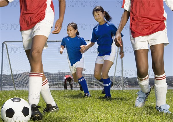 Multi-ethnic children playing soccer