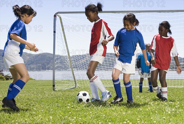 Multi-ethnic children playing soccer