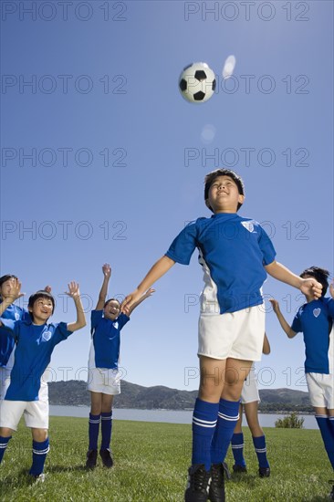 Multi-ethnic children playing soccer