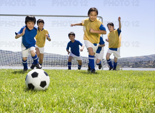 Multi-ethnic children playing soccer