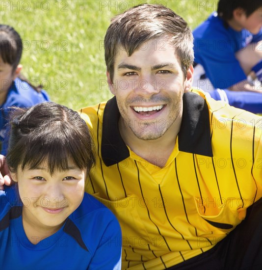 Portrait of Asian girl and soccer coach