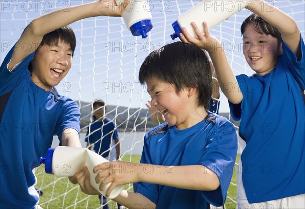 Asian boys playing with water bottles