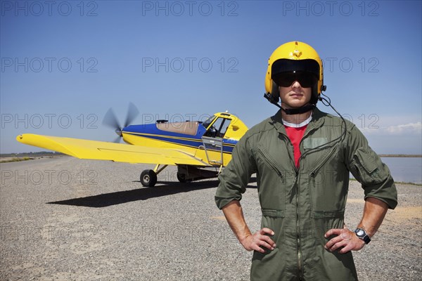 Pilot standing near small airplane