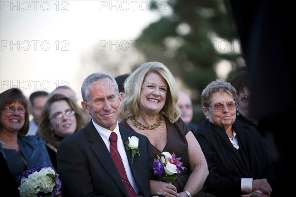 Family and guests watching wedding