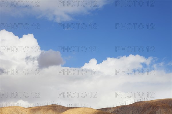 Blue sky and wind farm on hilltop