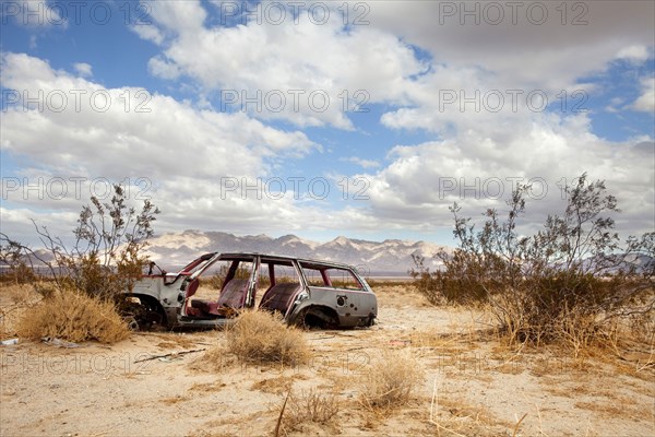 Wrecked car in barren area