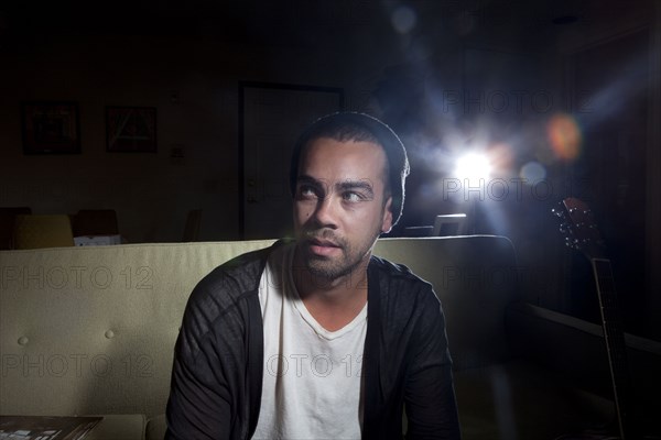 Mixed race man sitting in nightclub