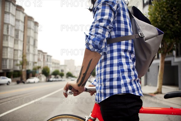 Vietnamese bicycle messenger on city street