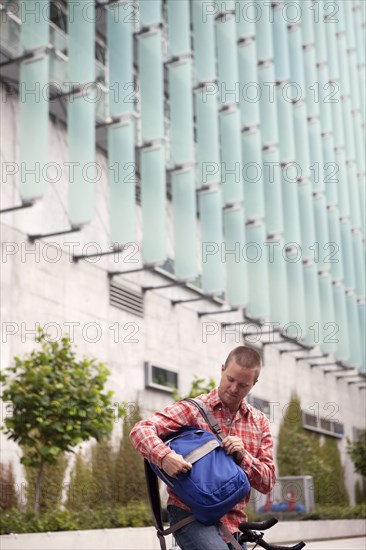 Bicycle messenger stopping on city street