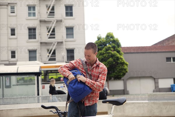 Bicycle messenger stopping on city street