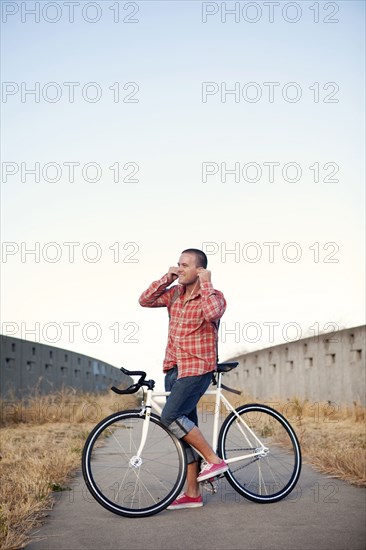 Bicycle messenger stopping on urban path