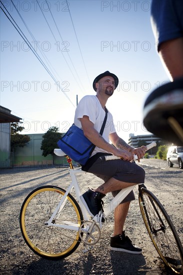 Bicycle messenger stopping on city street