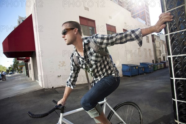 Bicycle messenger stopping on city street