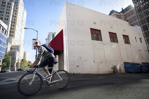 Bicycle messenger riding on city street