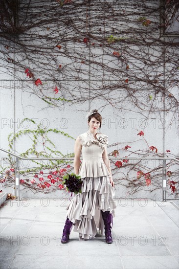 Glamorous bride standing with bouquet