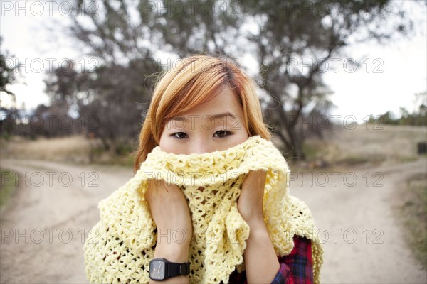 Korean woman covering  her face with scarf