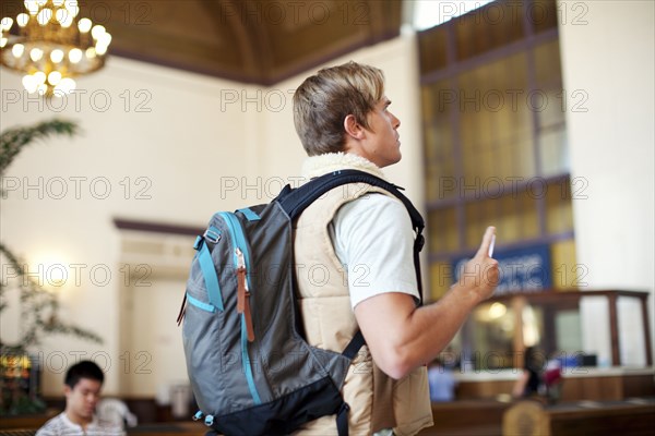 Caucasian man with backpack in train station