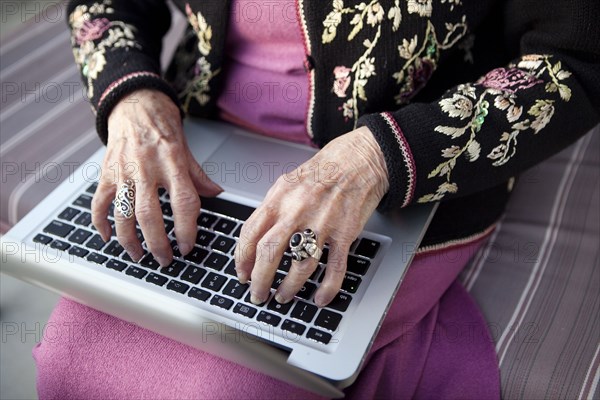 Senior Caucasian woman typing on laptop