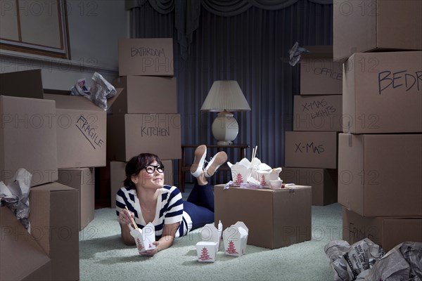 Korean woman eating take-out in new home