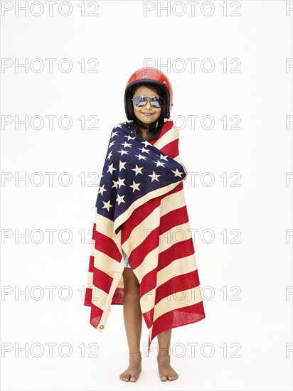 Mixed race girl wrapped in American flag